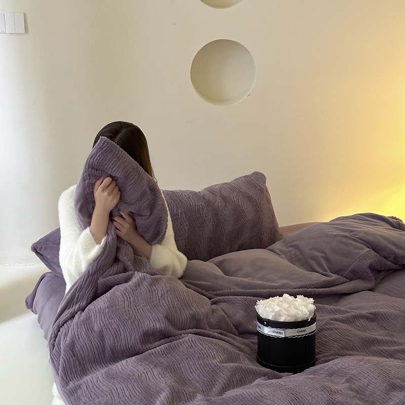 Wave textured plush bedding – dusty lavender model holding a pillow on the bed - Roomden