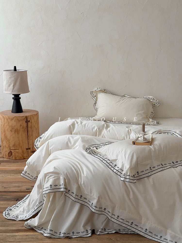 Scalloped embroidered washed cotton bedding set – Ink White, full bed arrangement - Roomden