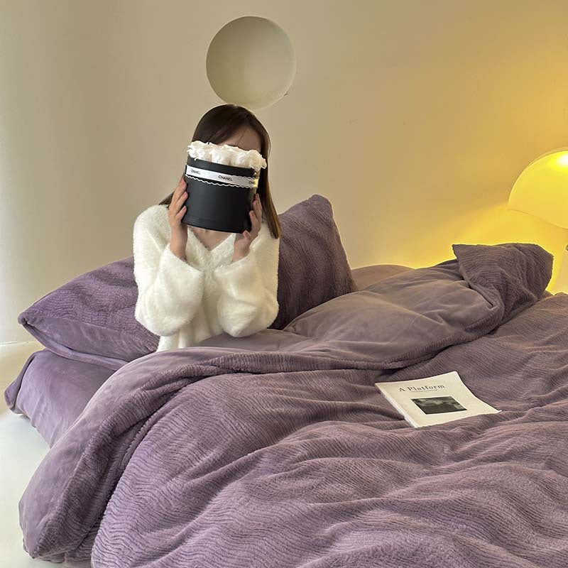 Wave textured plush bedding – dusty lavender model seated on the bed holding flowers - Roomden