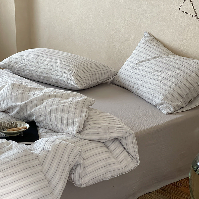 Halden Striped Cotton Double Gauze Bedding Set – grey pillows and folded gauze on the bed - Roomden