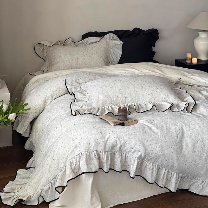 Marchbrook ruffled cotton double-gauze bedding set – front view with black-piped ruffles - Roomden