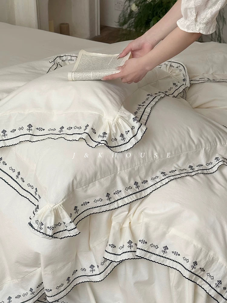 Scalloped embroidered washed cotton bedding set – Ink White, embroidered border held open - Roomden
