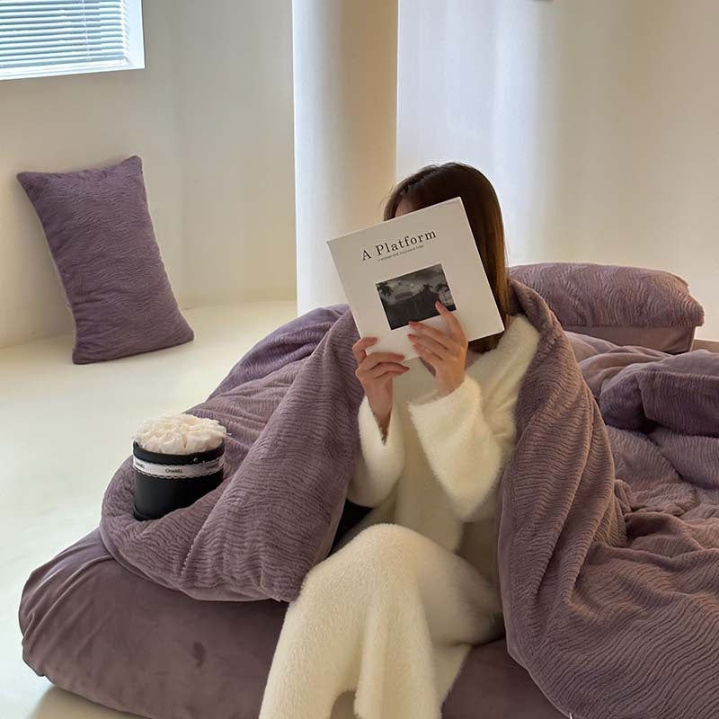 Wave textured plush bedding – dusty lavender model wrapped in the duvet beside the window - Roomden