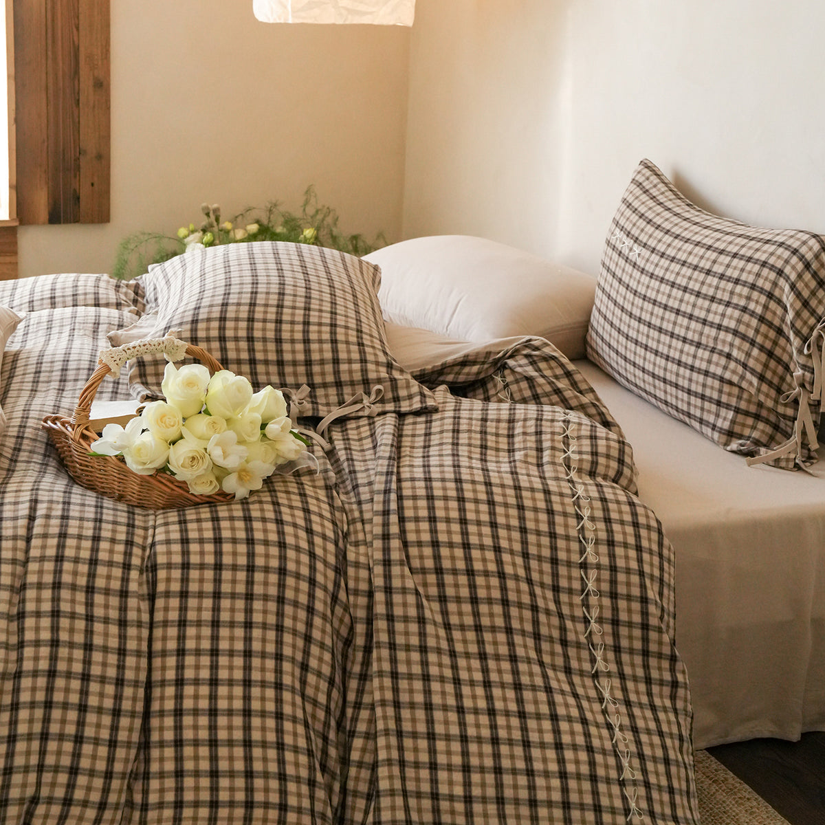 Checked Cotton Bedding Set with Bows and Lace – tea check duvet and pillows beside a window - Roomden