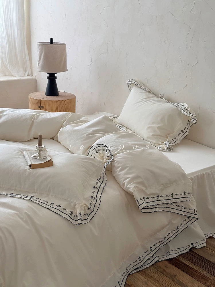 Scalloped embroidered washed cotton bedding set – Ink White, side view of the duvet and pillows - Roomden