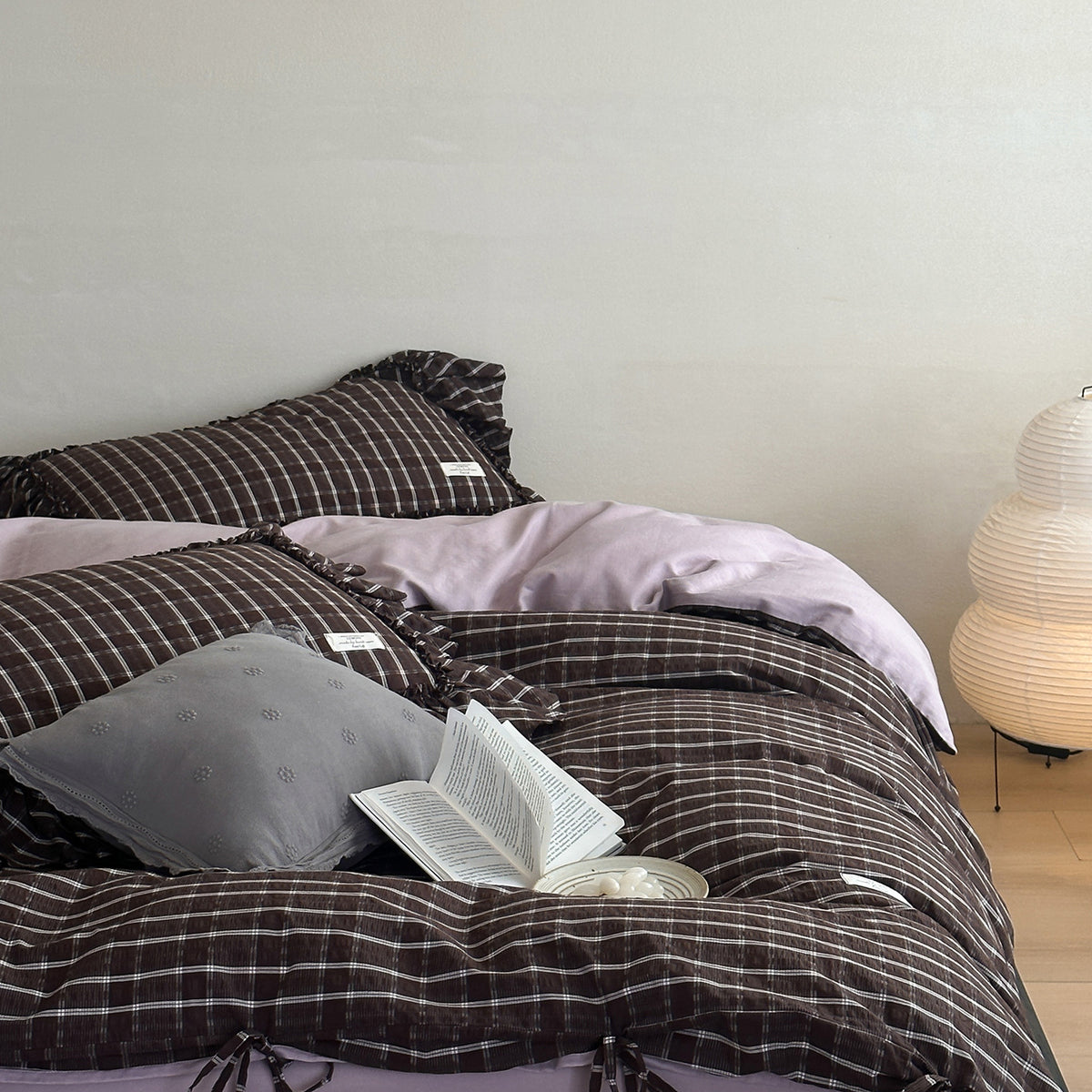 Cocoa Windowpane Ruffle Washed Cotton Bedding Set – Cocoa Windowpane, rumpled duvet with a book on the bed - Roomden
