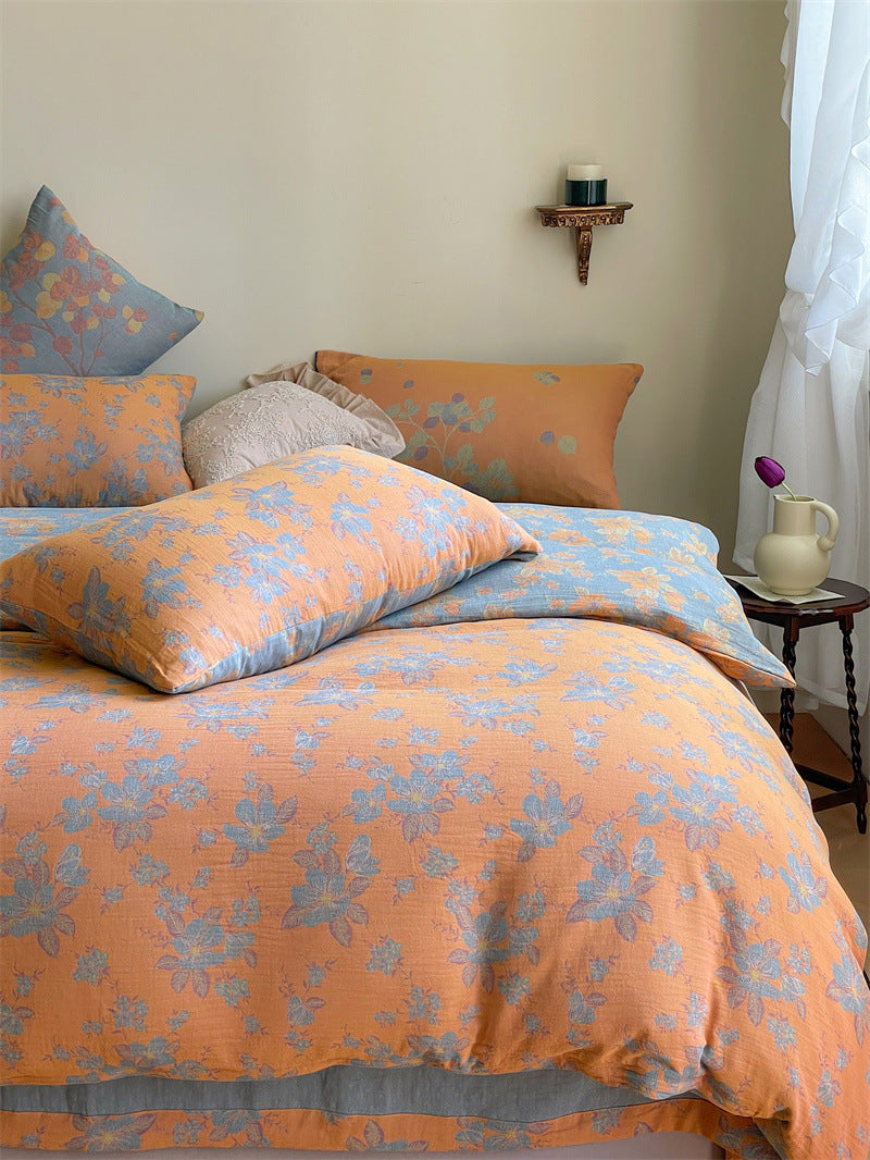 Ornella Apricot Floral Scroll bedding set – apricot floral scroll, angled view of the duvet and coordinating pillows, view 2 - Roomden