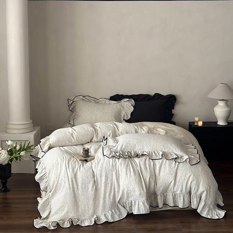 Black-Piped Ruffle Double Gauze Cotton Bedding Set – Oat Heather, full bed framed by a column and bedside tables - Roomden