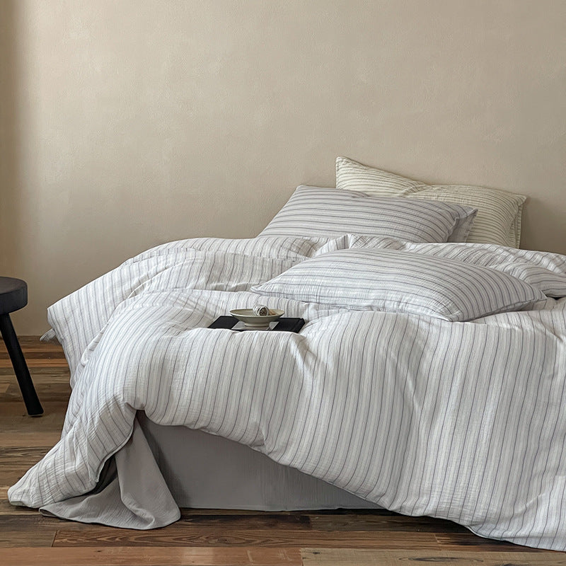 Halden Striped Cotton Double Gauze Bedding Set – side view of the grey duvet draping over the bed - Roomden