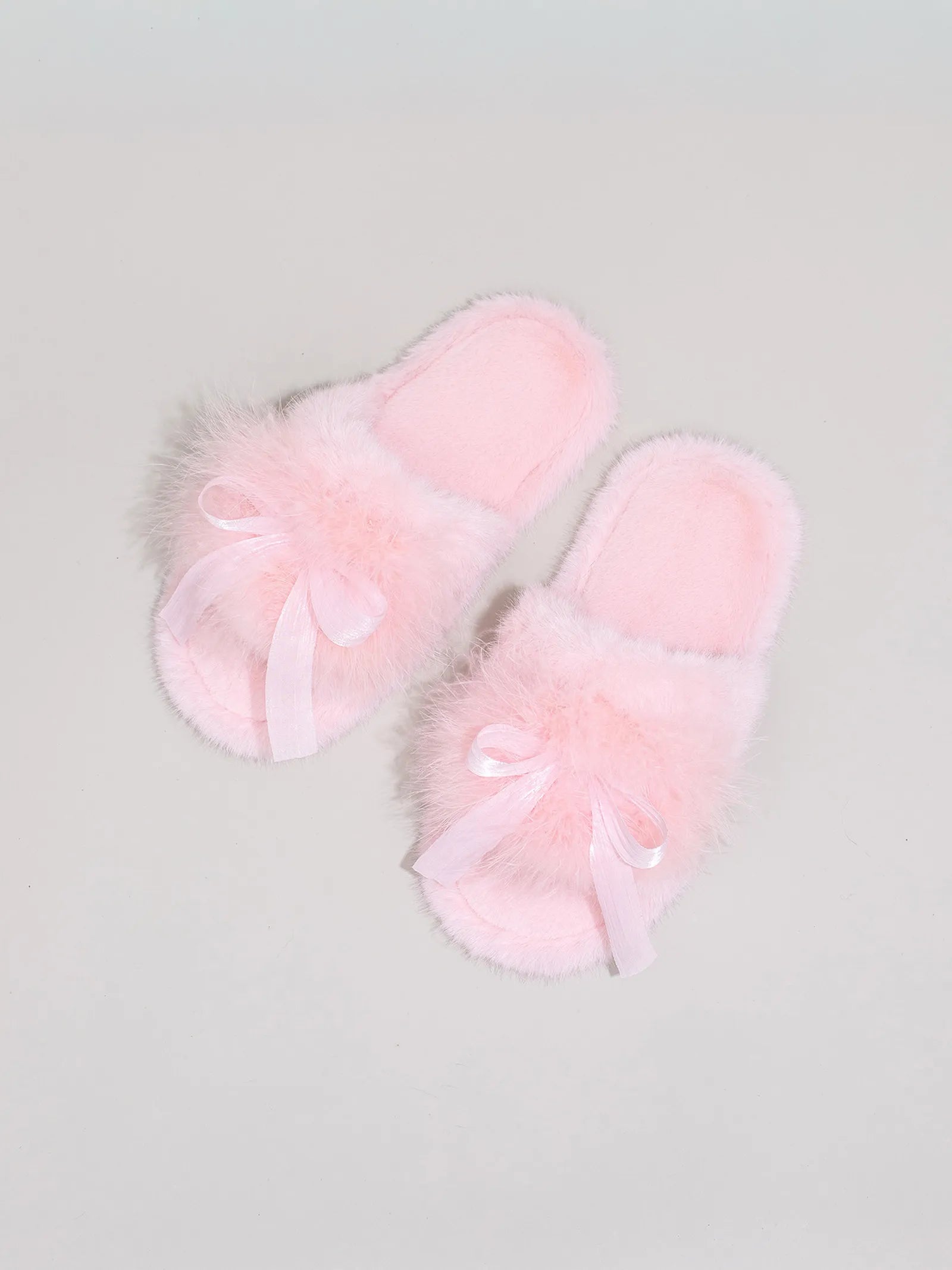 Top down view of Baby Pink fuzzy slippers highlighting the satin bow knot