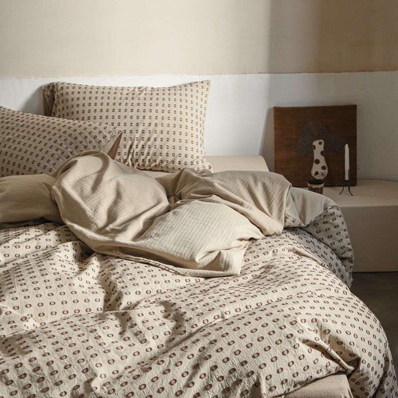 Amberlyn Cream Dotted cotton bedding set – bedroom view of the patterned duvet and pillows - Roomden