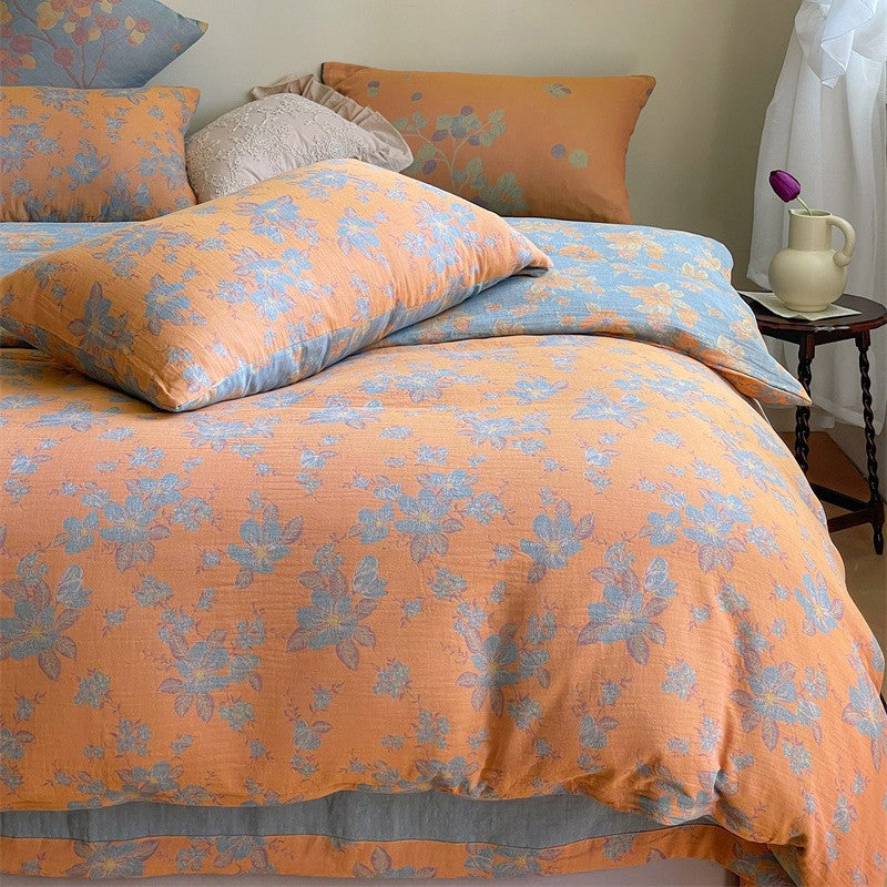 Ornella Apricot Floral Scroll bedding set – apricot floral scroll, bedroom view of the duvet and pillows, view 1 - Roomden