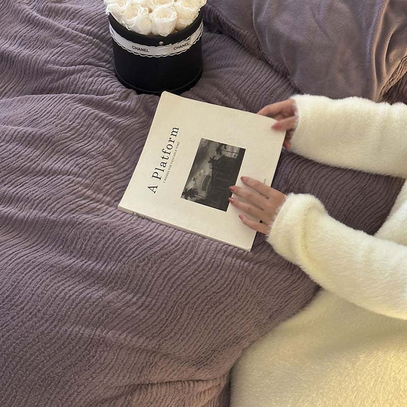 Wave textured plush bedding – dusty lavender textured duvet beside a book - Roomden