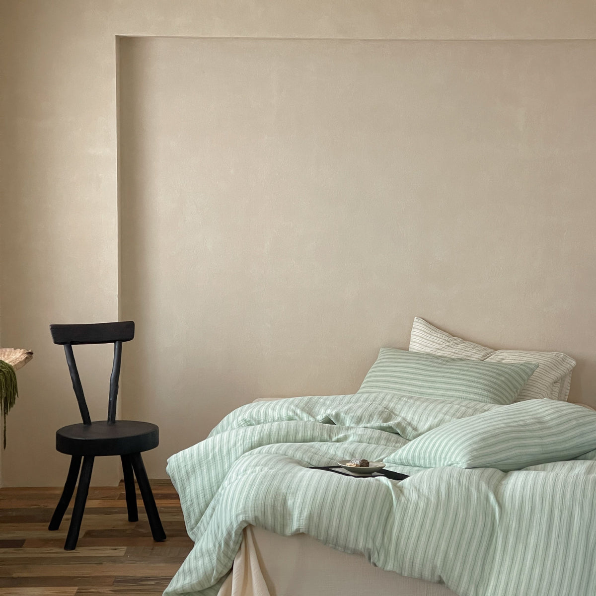 Halden Striped Cotton Double Gauze Bedding Set – sage duvet and pillows beside a wooden floor - Roomden
