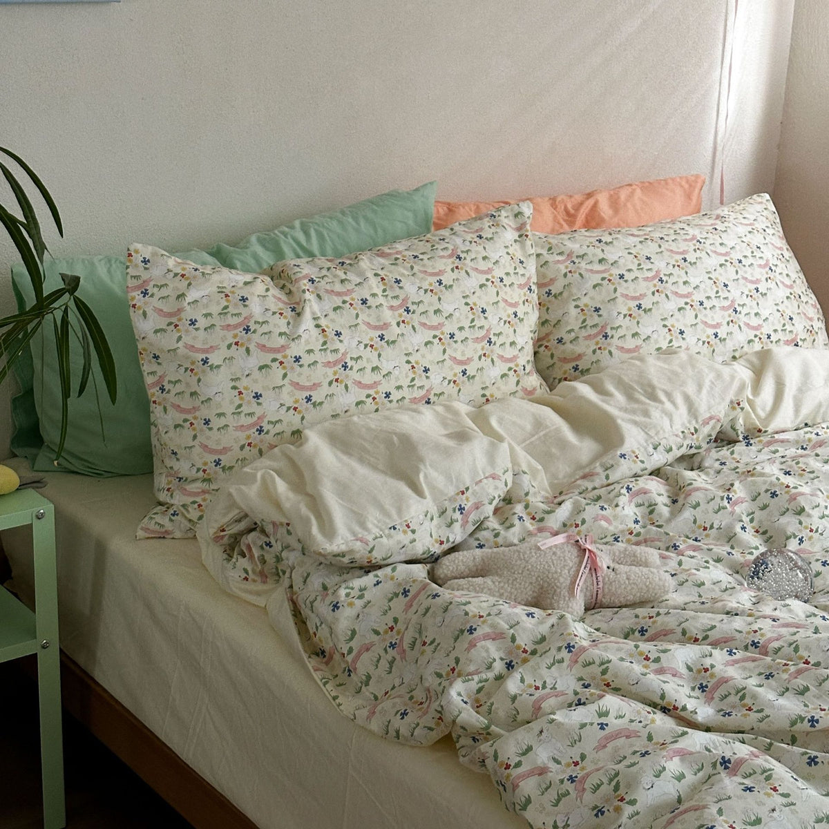 Colorful meadow floral cotton bedding showing matching patterned pillows and a plain cream reverse - Roomden