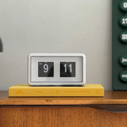 Direct front shot of the retro flip desk clock placed on a book. - RoomDen