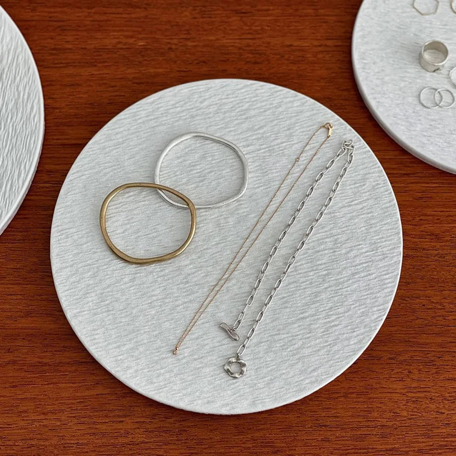 Detail shot of the medium Wabi-Sabi ceramic tray with gold and silver bracelets and chains, showing the surface texture. - RoomDen