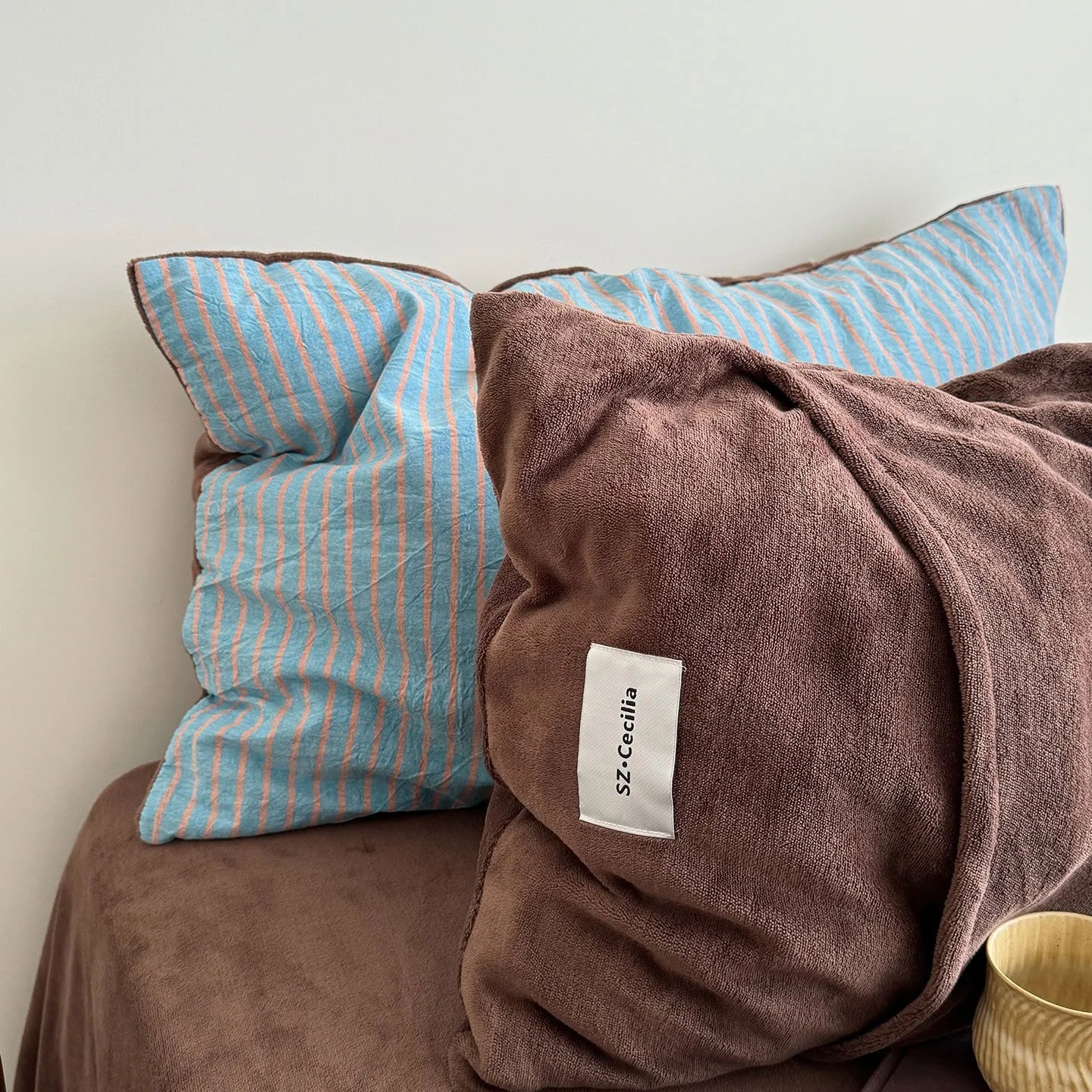 Detail of the reversible pillowcases in the Brown & Blue colorway.