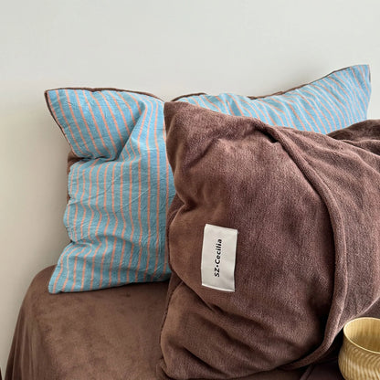 Detail of the reversible pillowcases in the Brown & Blue colorway.
