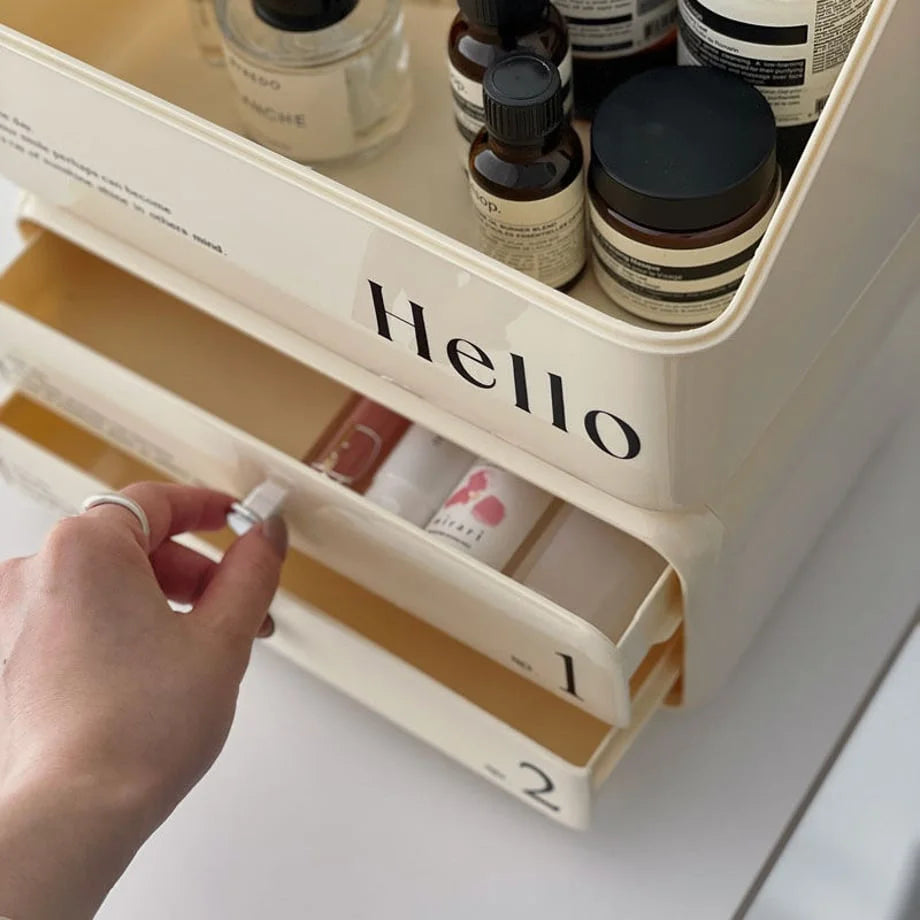 Close-up of a hand opening a drawer of the retro makeup organizer, revealing cosmetics inside.