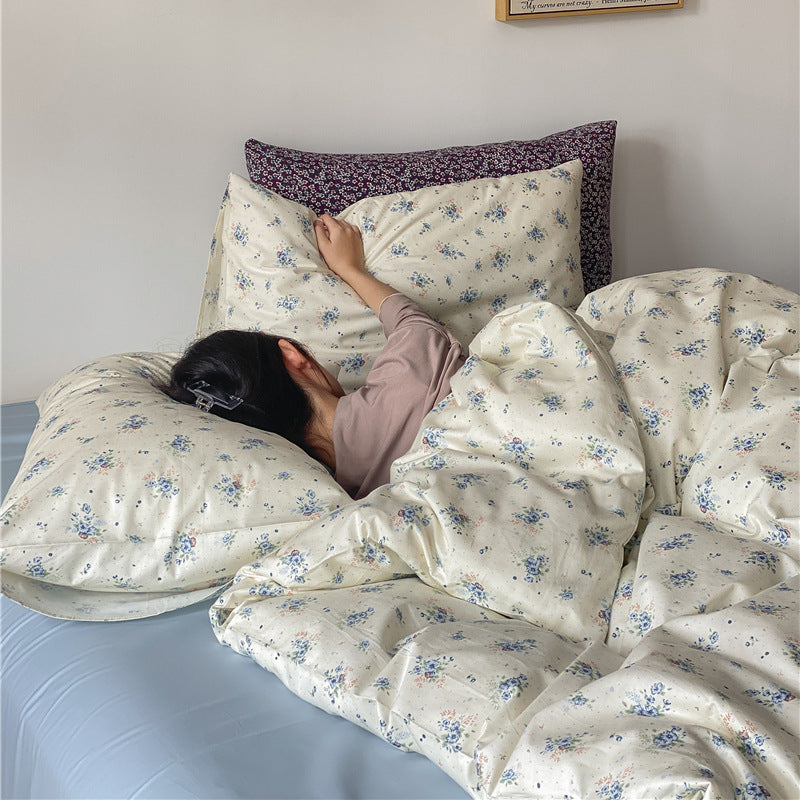 Ivory Blue Floral Cotton Bedding Set – matching floral pillows and softly folded duvet in a bedroom scene - Roomden
