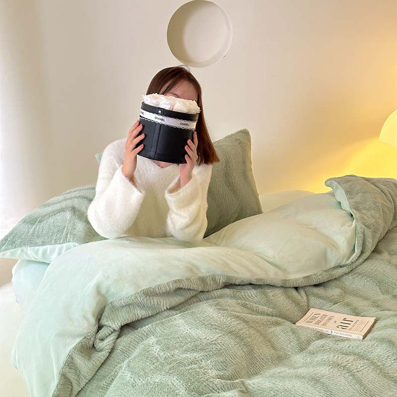 Wave textured plush bedding – sage green model seated with the smooth reverse folded back - Roomden