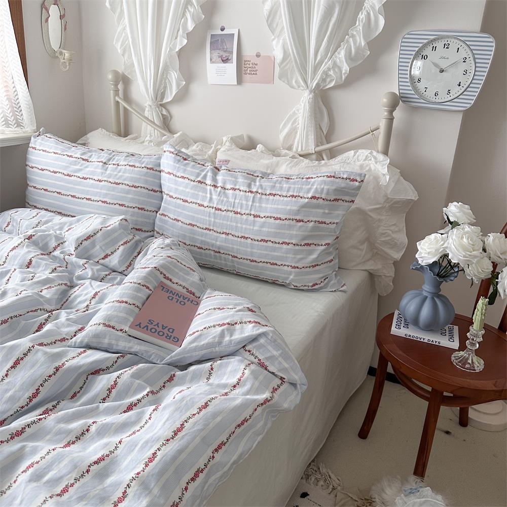 Pale Blue Floral Stripe Cotton Bedding Set – full bed scene showing the printed duvet and pillow arrangement - Roomden