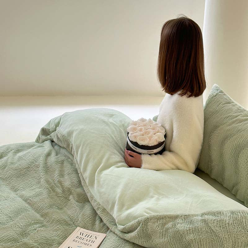 Wave textured plush bedding – sage green side view of the model and layered bedding - Roomden