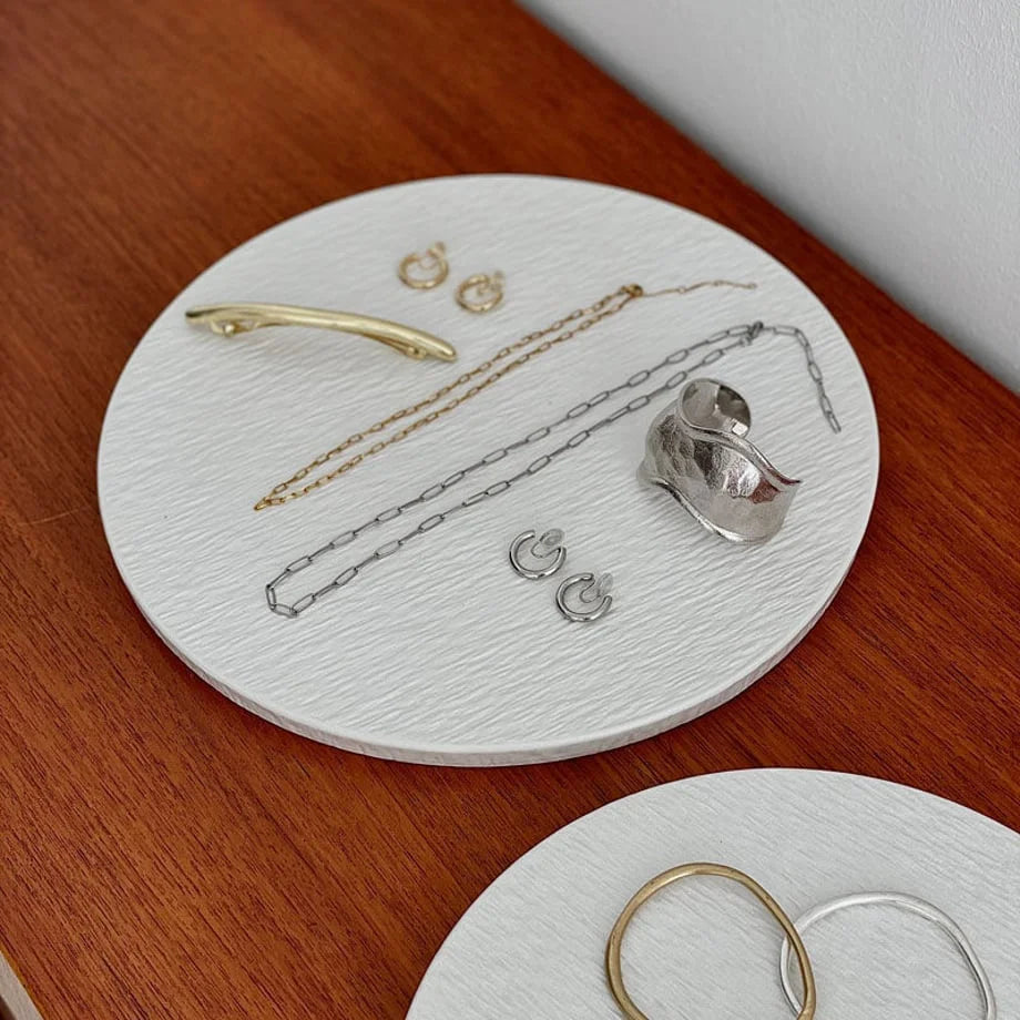 Angled close-up of the large ceramic tray, focusing on the arrangement of gold and silver jewelry. - RoomDen