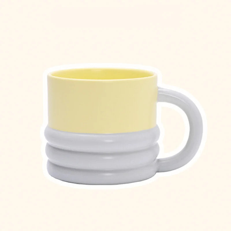 Front view of the chunky ribbed ceramic mug in a two-tone yellow and grey finish - RoomDen.
