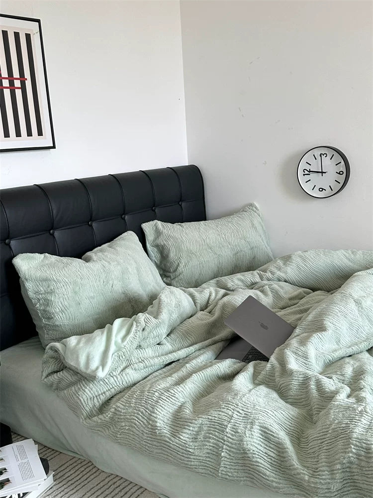 Wave textured plush bedding – sage green bed against a dark upholstered headboard - Roomden