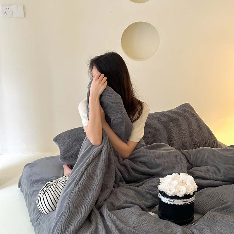 Wave textured plush bedding – charcoal grey model seated beneath the textured duvet - Roomden