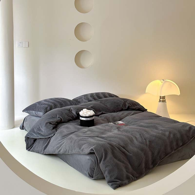 Wave textured plush bedding – charcoal grey full bed on a curved white platform - Roomden