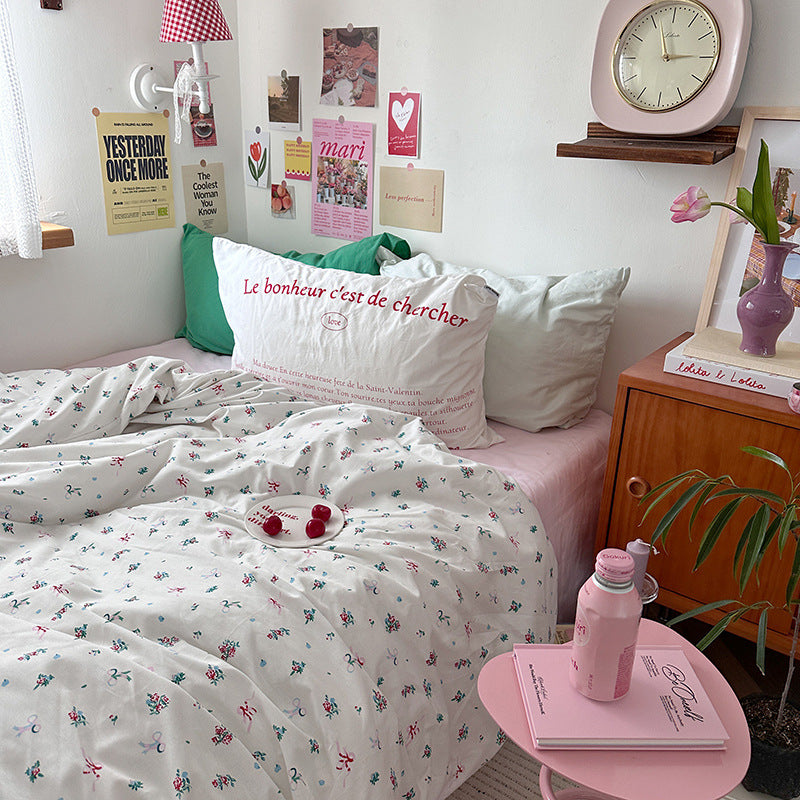 Ivory floral and bow cotton bedding – small bouquets with a lettering pillow in a pink-accented room - Roomden