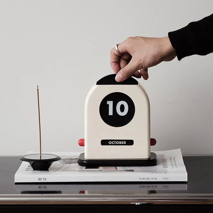 Retro Wooden Perpetual Desk Calendar on a stack of books next to an incense holder - RoomDen
