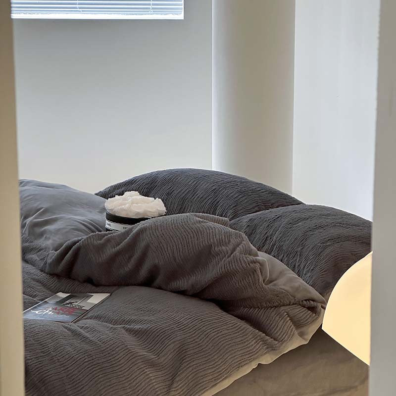 Wave textured plush bedding – charcoal grey pillows beside the window - Roomden