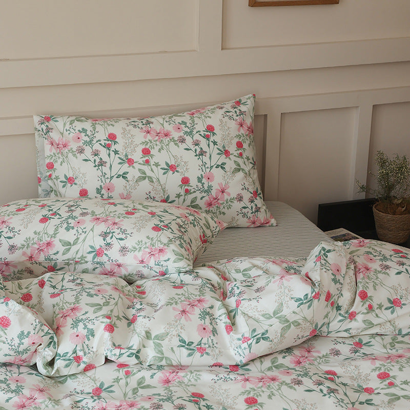 Side view of pink meadow flowers on ivory cotton bedding - Roomden