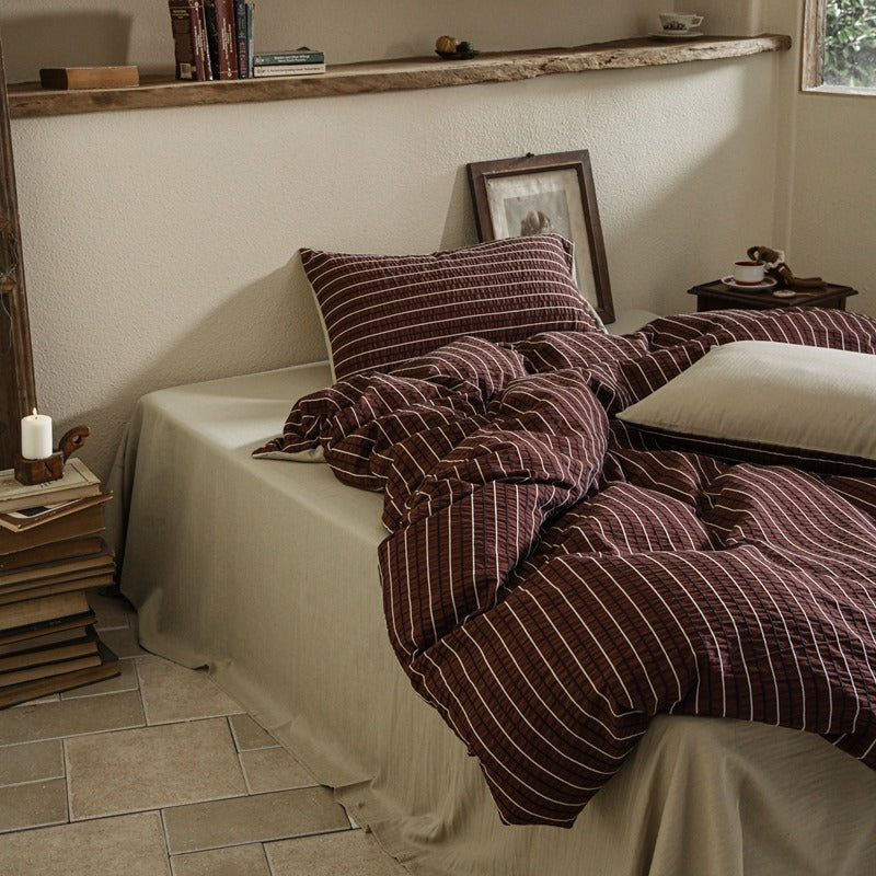 Amberlyn Burgundy Fine Stripe cotton bedding set – bedroom view of the patterned duvet and pillows - Roomden