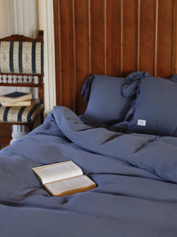 Soft Ruffle Cotton Double Gauze Bedding Set – dusty blue pillows and duvet on a dark bed frame - Roomden