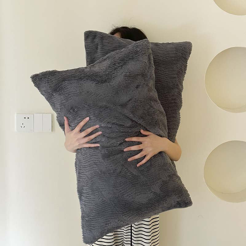 Wave textured plush bedding – charcoal grey model holding the matching pillows - Roomden