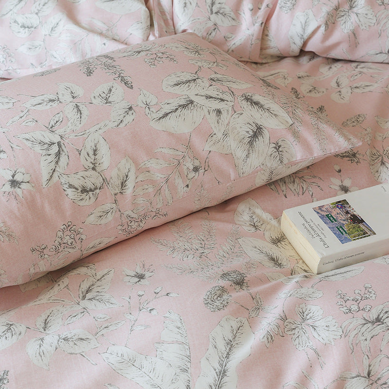 Close view of pale botanical sketches on blush cotton bedding - Roomden