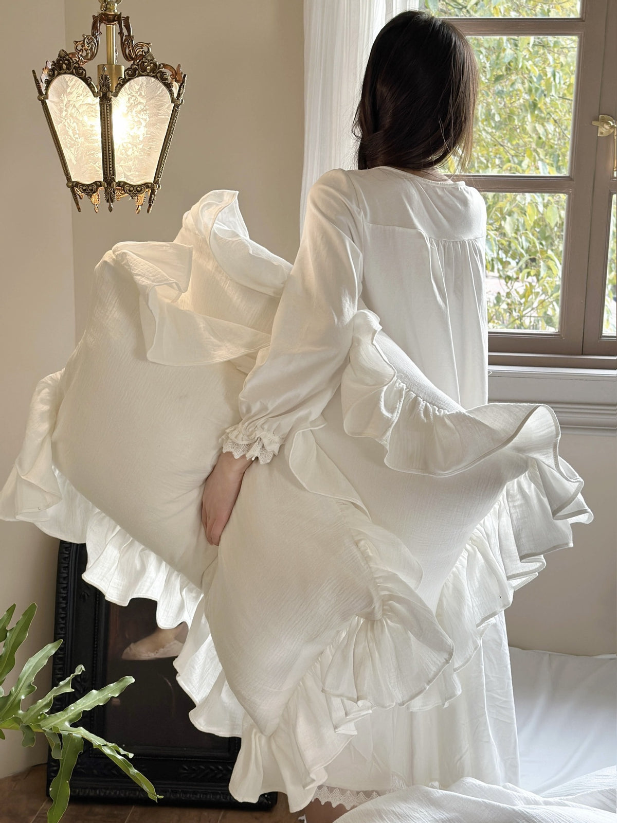 Ruffled Double Gauze Cotton Bedding Set – Scalloped Ivory, bedding draped at the foot of the bed with a standing figure - Roomden