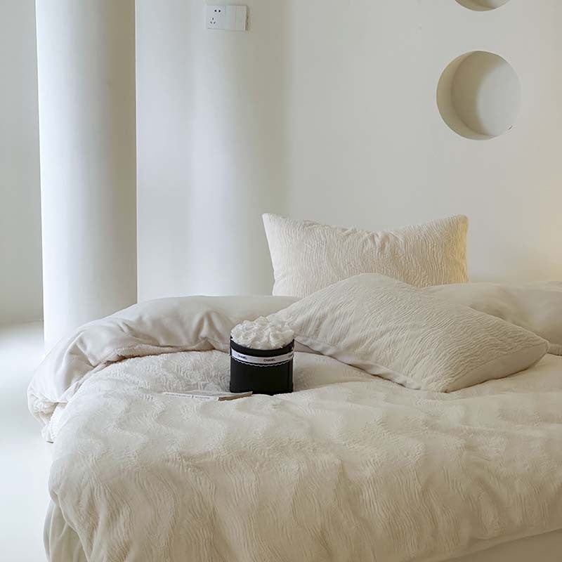 Wave textured plush bedding – creamy white front view of the bed on a white platform - Roomden