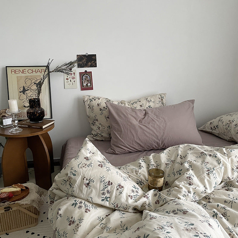 Florhaven Ink Sprig cotton bedding set – bedroom view of dark sprigs on a pale duvet and taupe sheet - Roomden