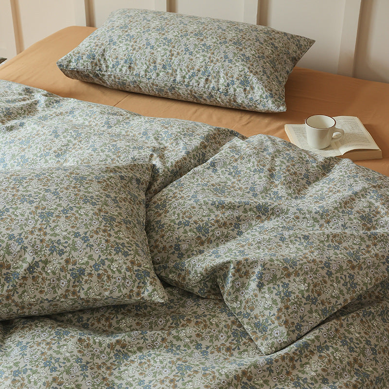 Close view of tiny blue and green flowers on ivory cotton bedding - Roomden