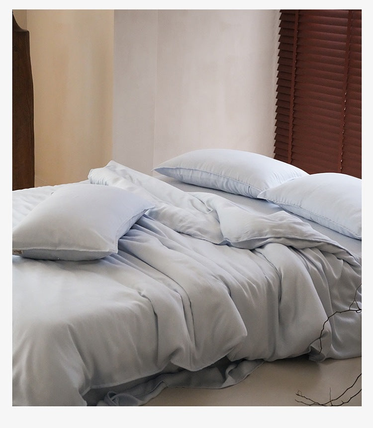 Sandwashed Lyocell Bedding Set – Mist Blue, relaxed bed arrangement showing the fabric drape - Roomden