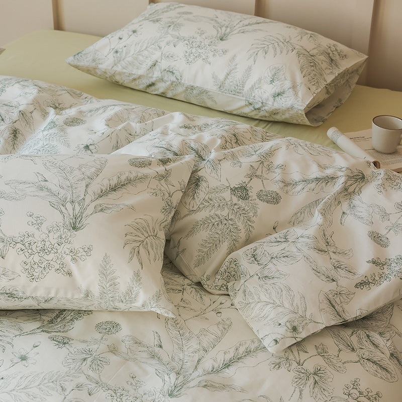 Close view of fine green botanical sketches on ivory cotton bedding - Roomden