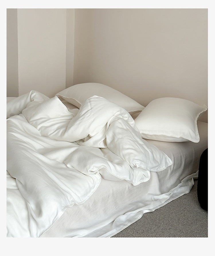 Sandwashed Lyocell Bedding Set – Moonlight White, relaxed bed arrangement showing the fabric drape - Roomden