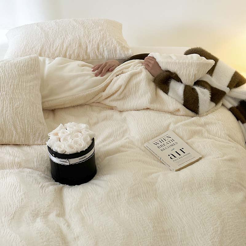 Wave textured plush bedding – creamy white model reclining on the bed - Roomden