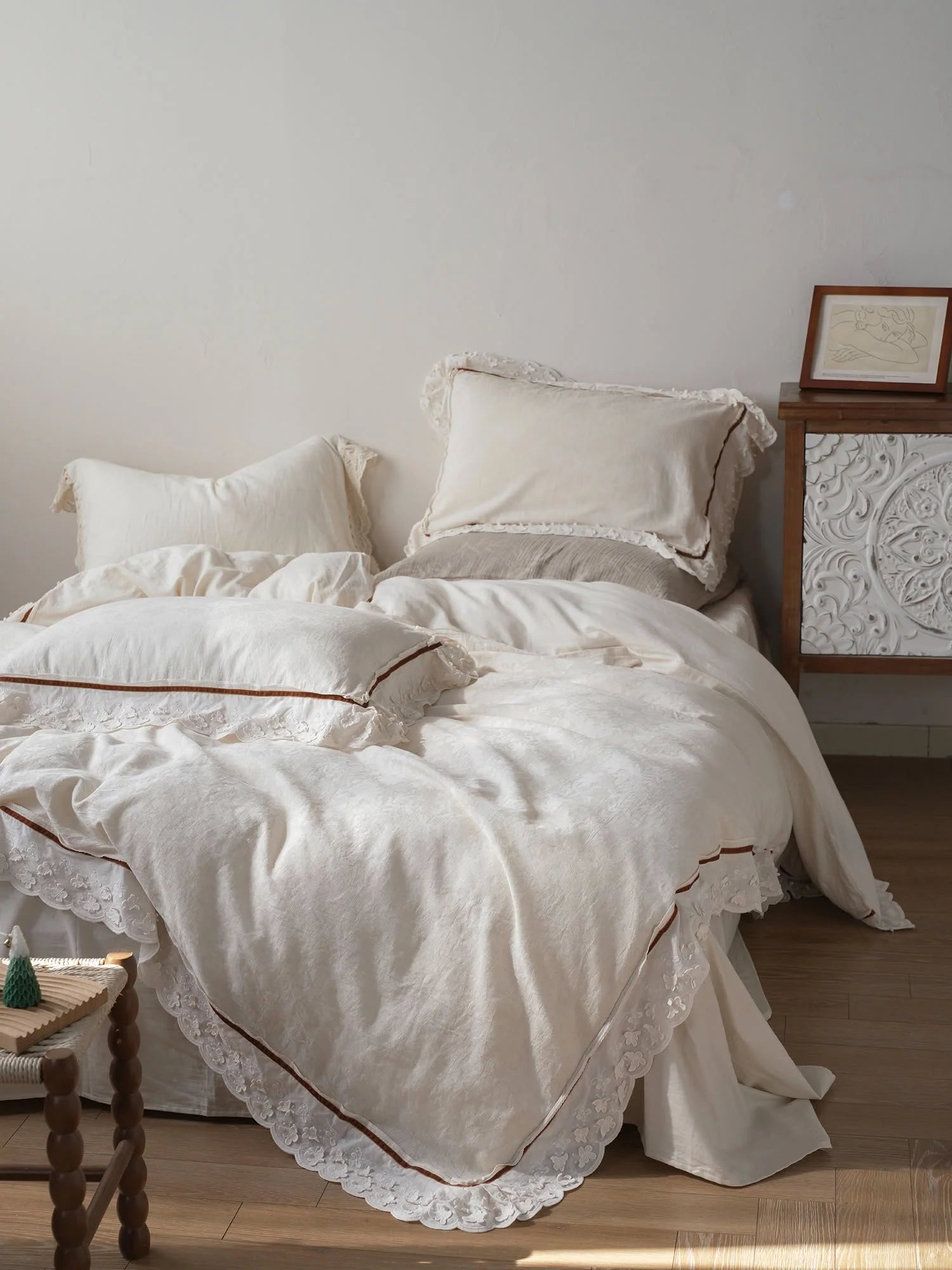 Textured Ruffle Lace Trim Linen Bedding Set in creamy white, styled on a bed in a sunlit room. - RoomDen